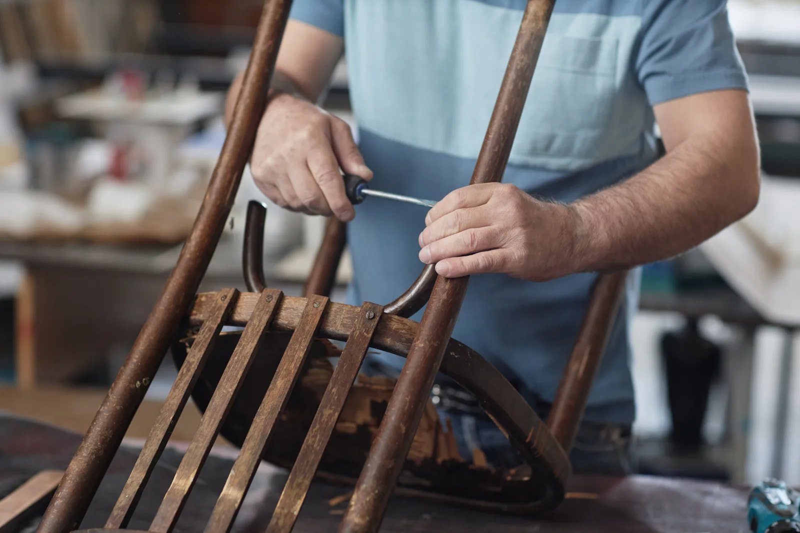 antique-furniture-repair-phoenix-craftsman-joint-repair Antique furniture repair in Phoenix, Arizona — a craftsman repairing a loose wood joint on an antique chair frame.
