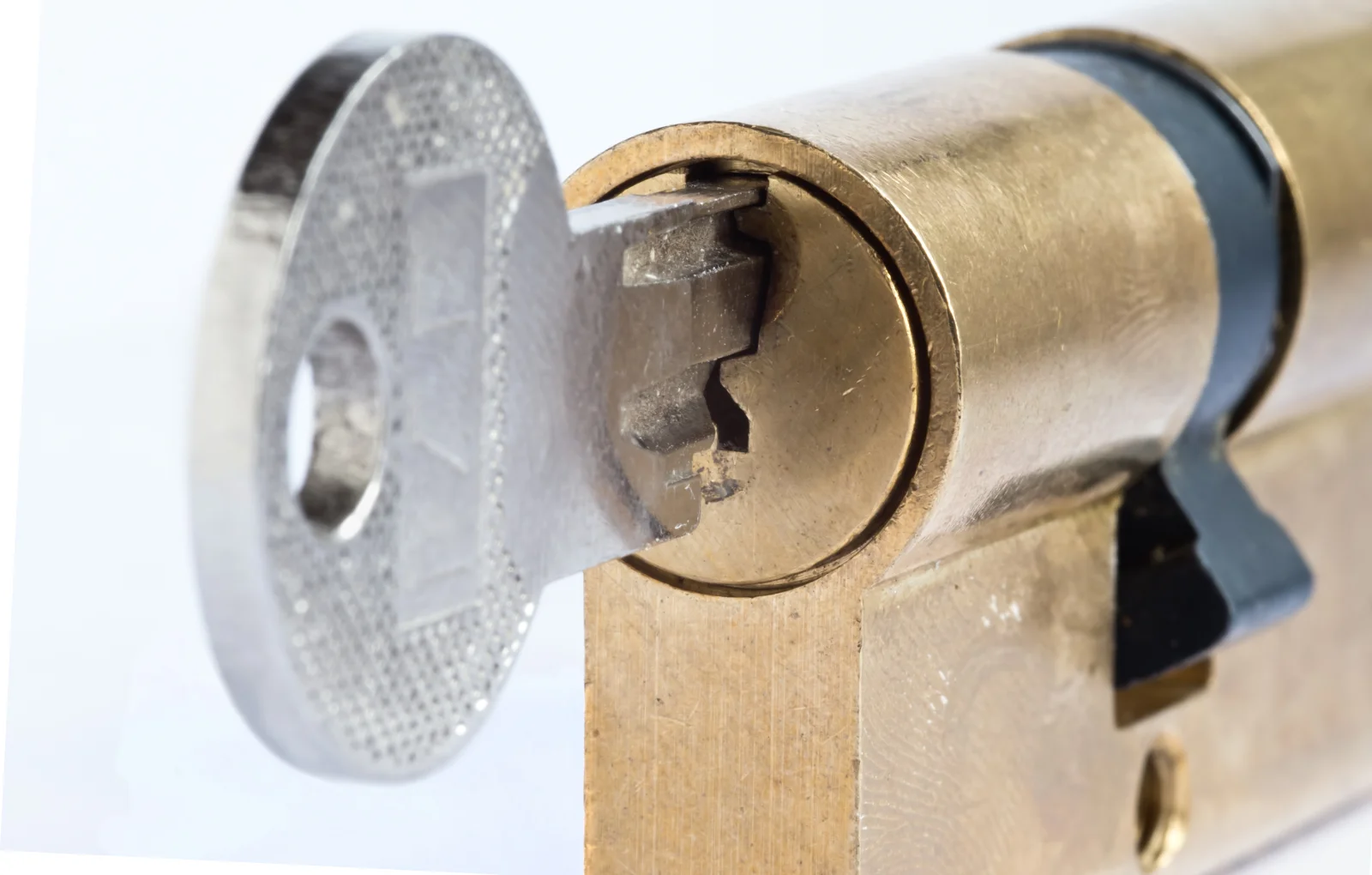 Broken key extraction in Phoenix, Arizona — the jagged broken end of a key wedged inside a brass door lock cylinder.