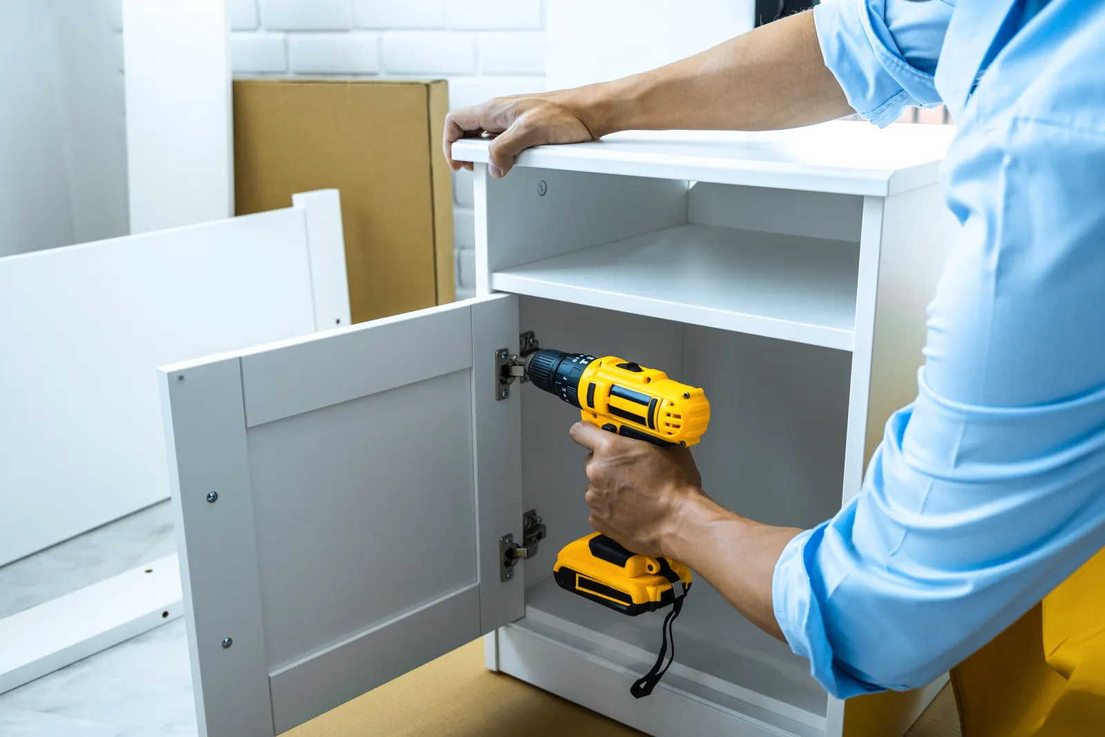 cabinet-refacing-phoenix-new-doors A carpenter fitting new doors and veneer during a kitchen cabinet refacing, the work ShowUp Promise connects Phoenix homeowners with.