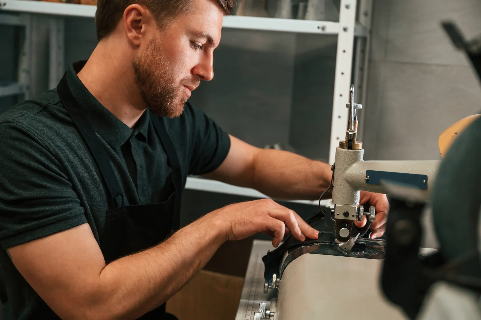 car-locksmith-phoenix-key-programming An automotive locksmith cutting and duplicating a car key at his workbench, one of the jobs a Phoenix car locksmith handles through ShowUp Promise.