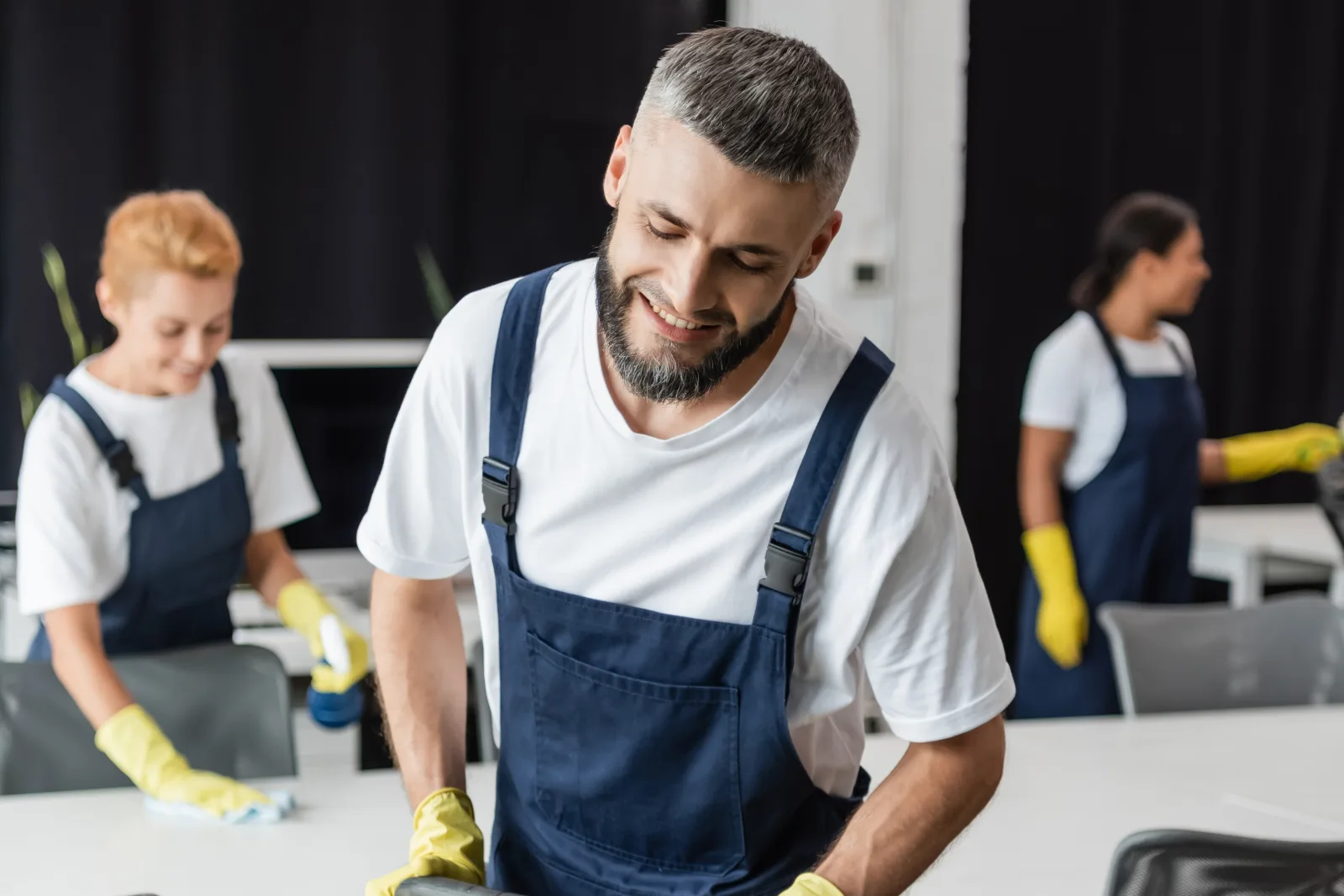 church-cleaning-phoenix-crew-in-uniform-cleaning Church cleaning in Phoenix, Arizona — a uniformed cleaning crew in navy coveralls and yellow gloves cleaning a facility together.