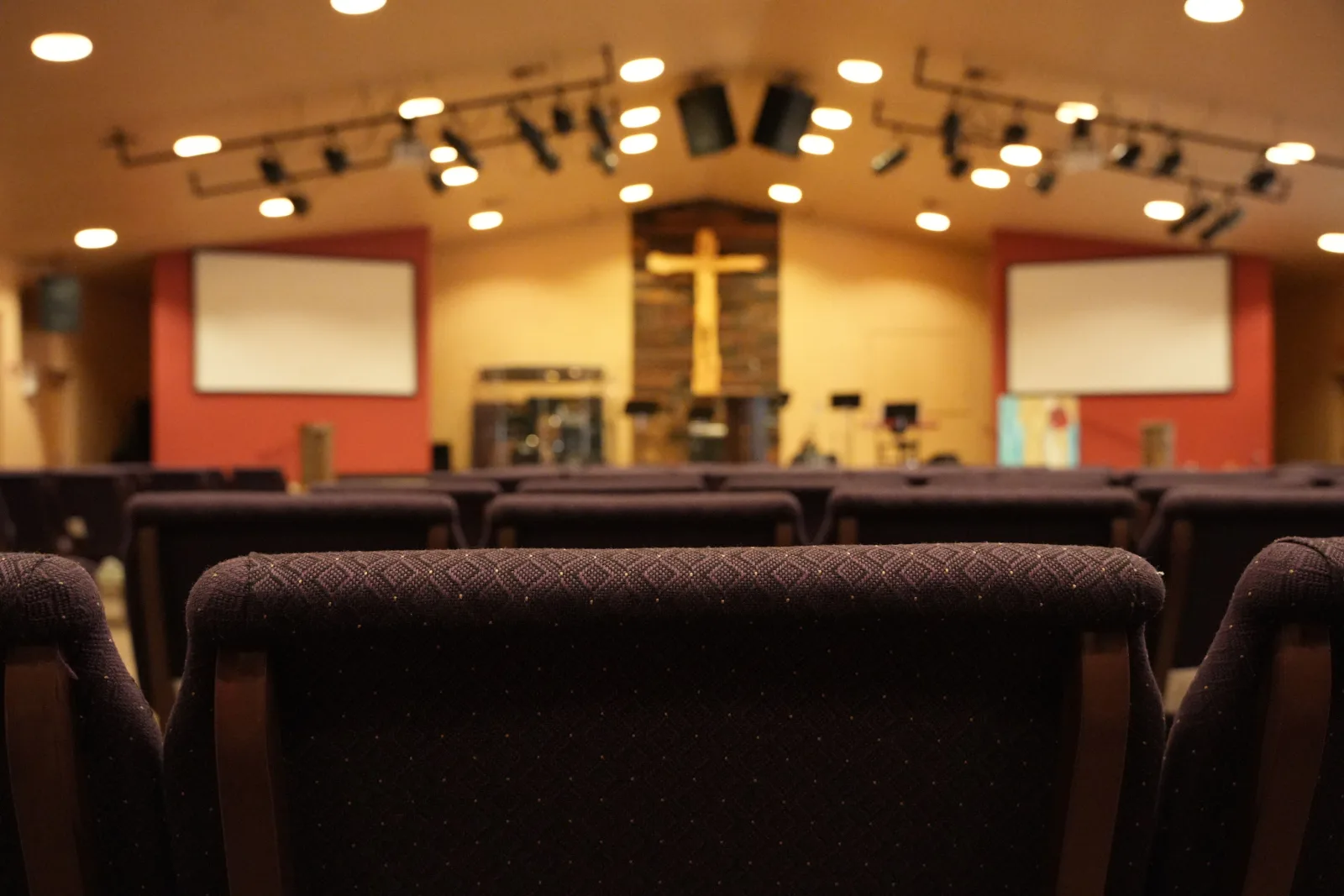 church-cleaning-phoenix-sanctuary-ready-for-service Church cleaning in Phoenix, Arizona — an empty, freshly cleaned modern sanctuary with upholstered seating, ready for Sunday service.