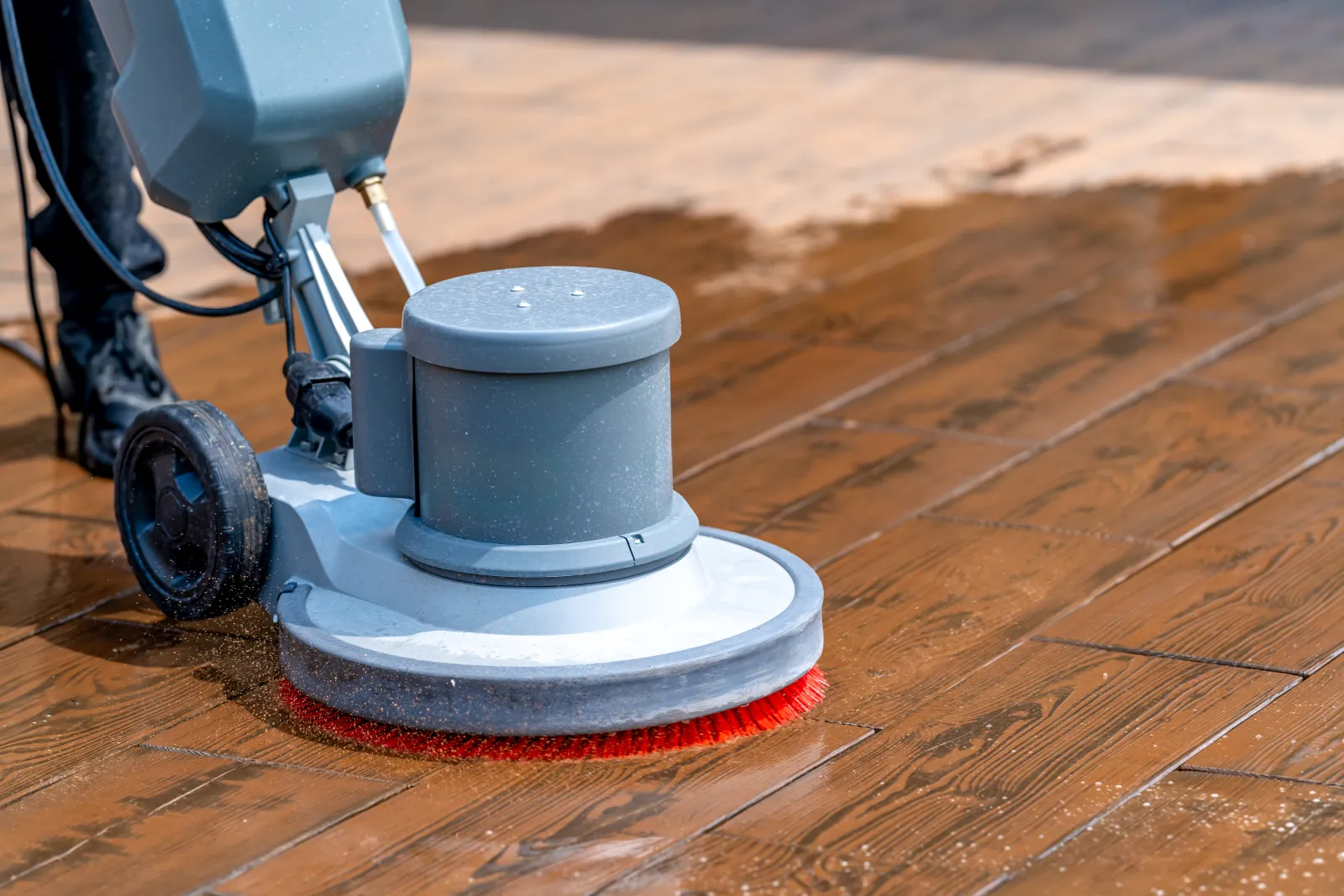 commercial-cleaning-phoenix-az-floor-care A commercial janitor buffing and polishing a hard facility floor with a floor machine during a strip-and-wax service at a Phoenix business.