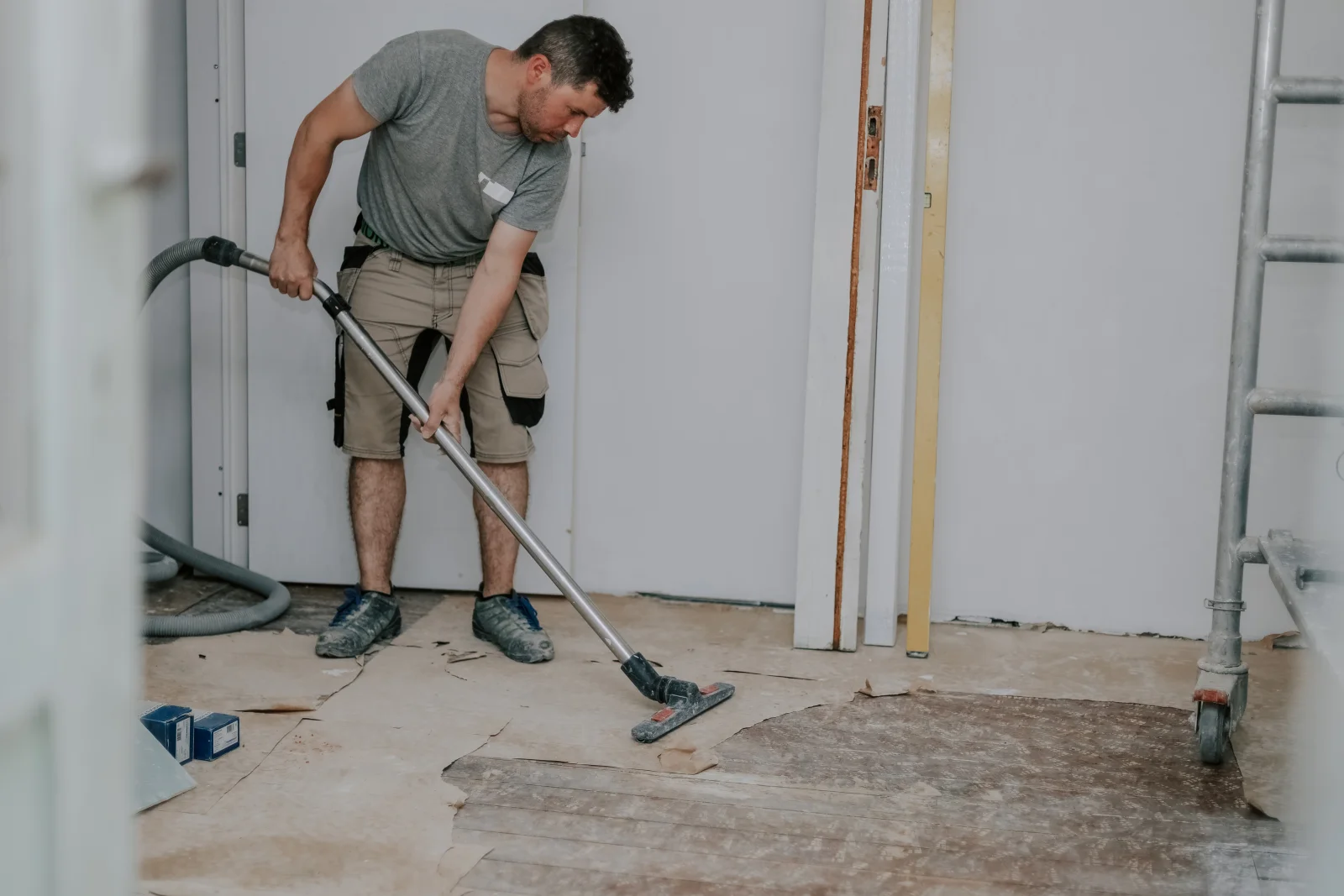 A cleaning crew removing construction dust and debris during a post-construction cleanup at a Phoenix commercial buildout.