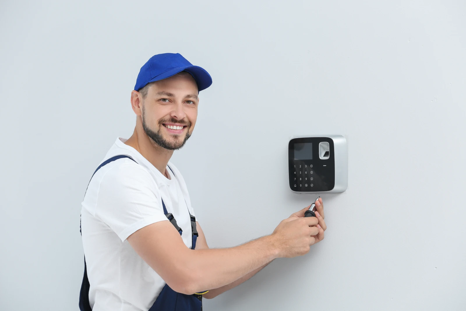 commercial-locksmith-phoenix-access-control A locksmith programming a commercial access-control keypad on an office door in Phoenix.