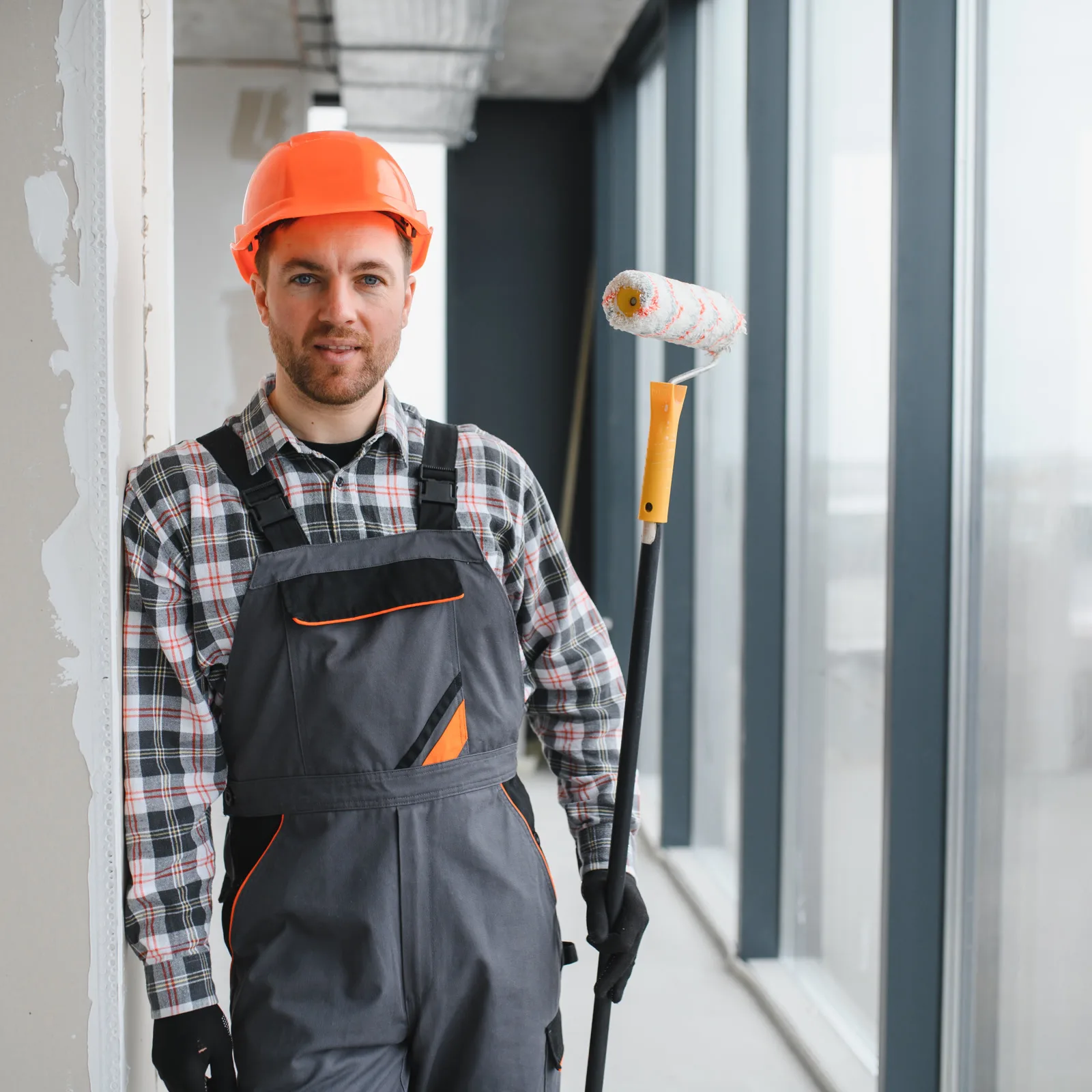 commercial-painting-companies-phoenix-exterior-repaint Commercial painting companies in Phoenix, Arizona — a uniformed painting contractor applying exterior paint to a Phoenix business building.