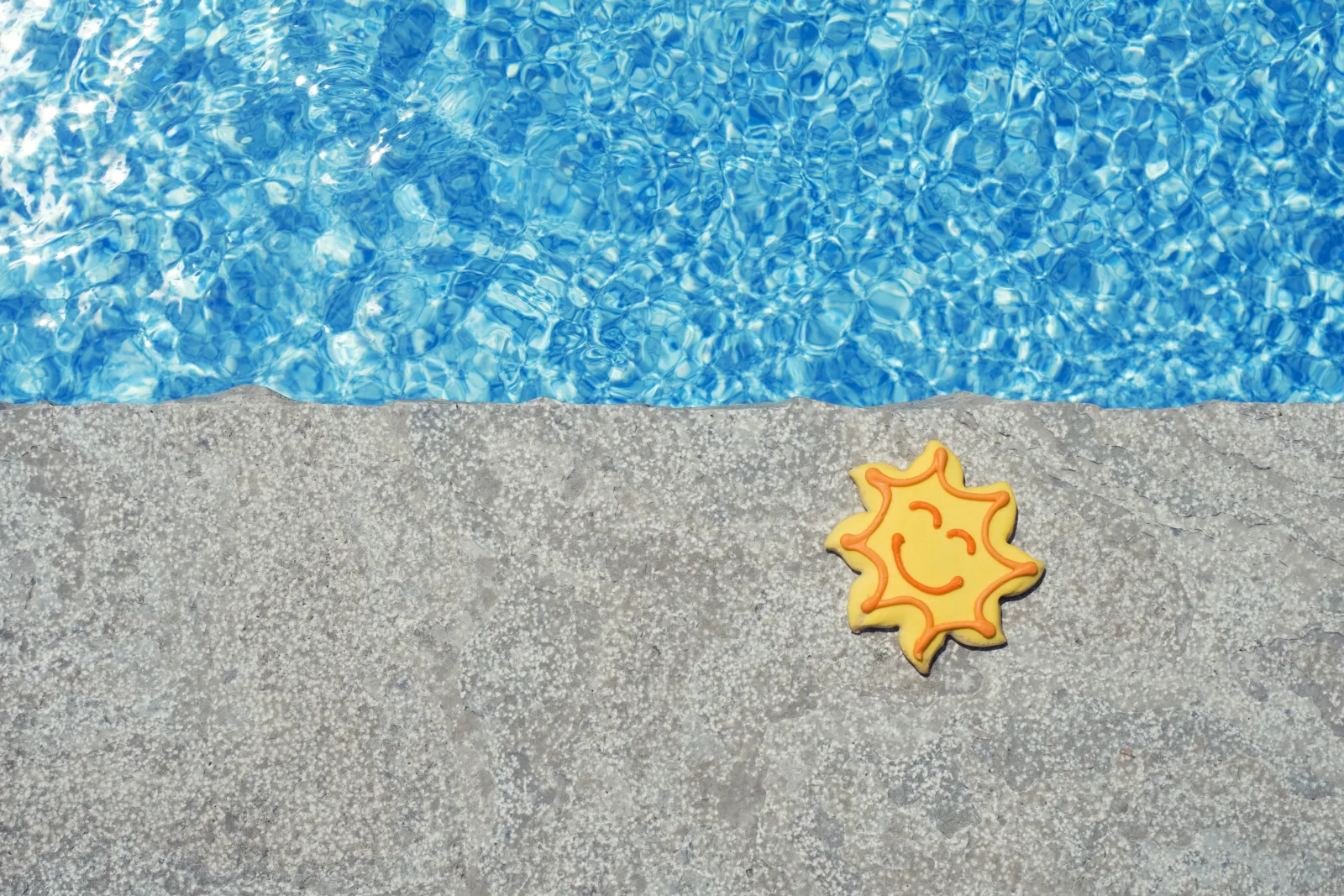 cool-deck-repair-phoenix-finished-recoat A freshly repaired and recoated light-colored cool deck around a backyard pool in Phoenix, the smooth cool-to-touch finish a repair pro restores after fixing cracks and peeling.