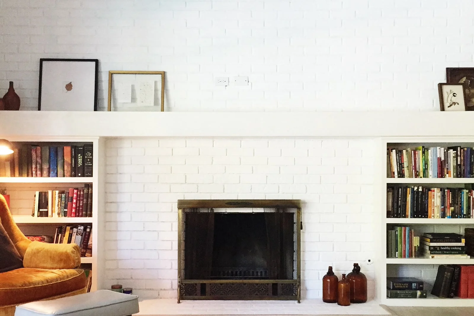 A finished custom built-in bookshelf and library wall in a Phoenix, Arizona home, showing floor-to-ceiling shelving.