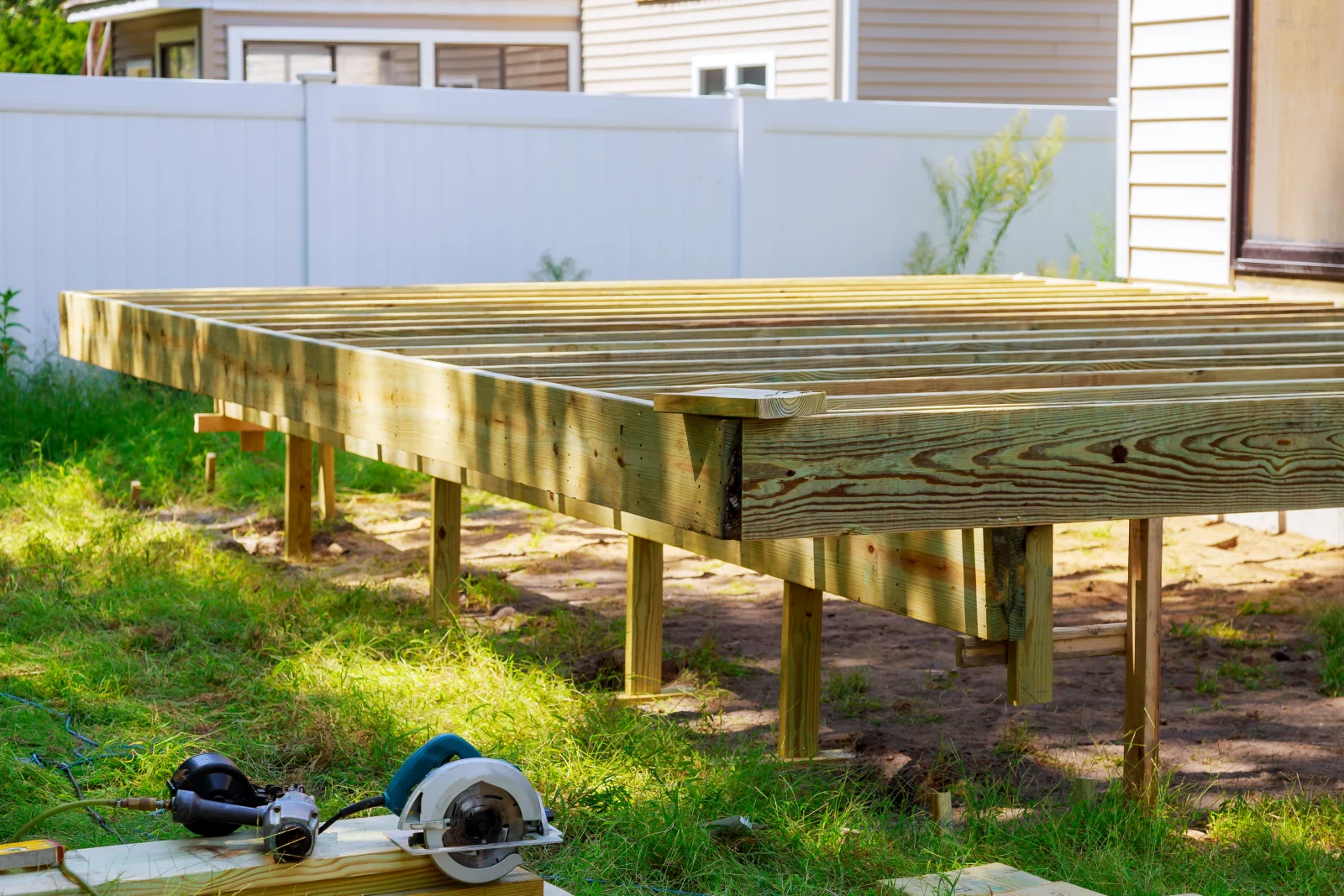 A newly framed deck substructure being built in a Phoenix, Arizona backyard, ready for decking boards.