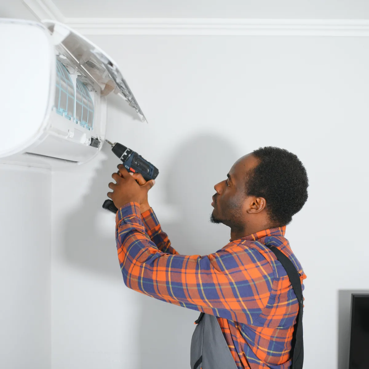 ductless-ac-replacement-phoenix-mini-split-install Ductless AC replacement in Phoenix, Arizona — a technician installing a new wall-mounted mini-split head in a desert home.