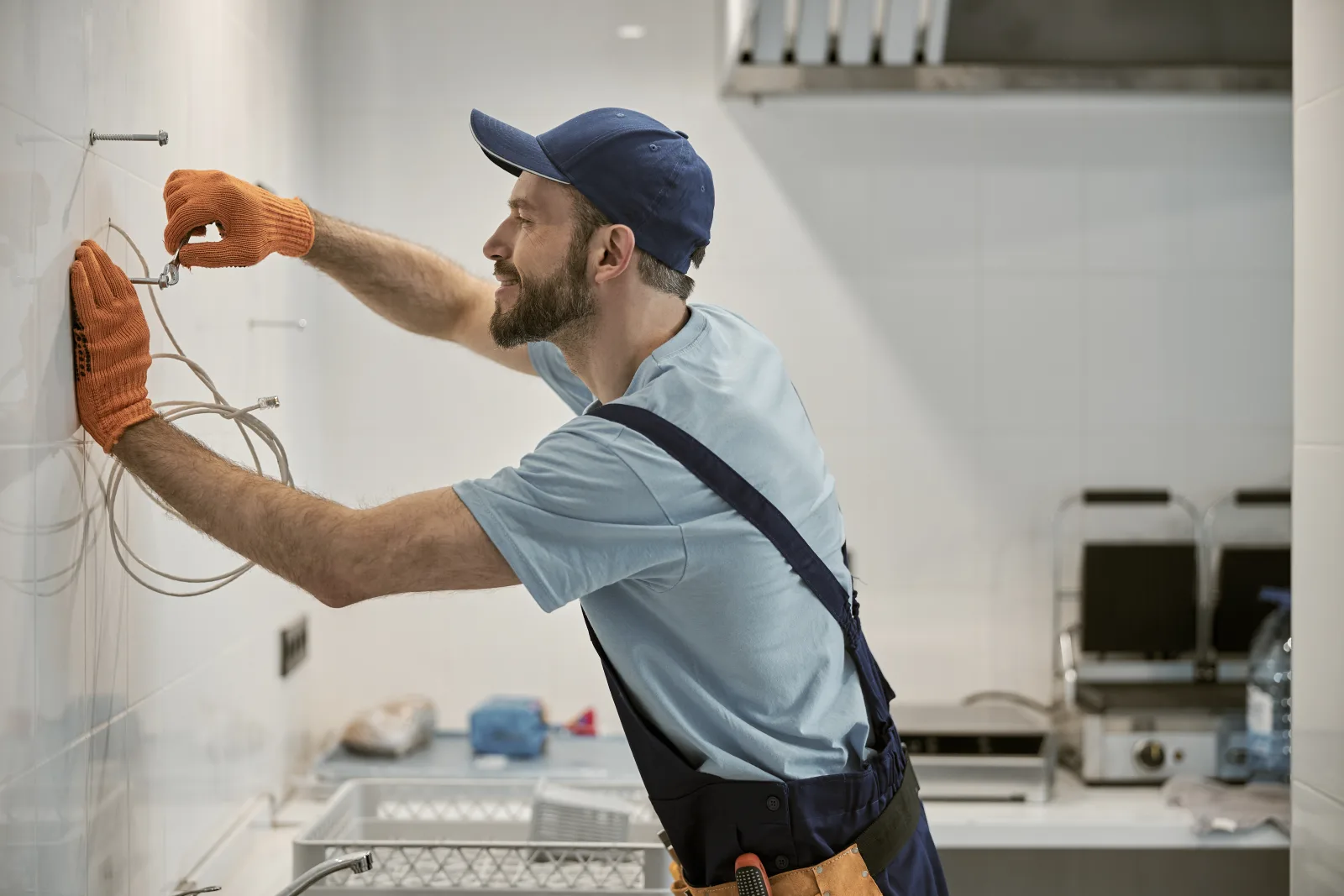 Electrical inspection in Phoenix, Arizona — an electrician wearing work gloves testing wiring connections during a home inspection.