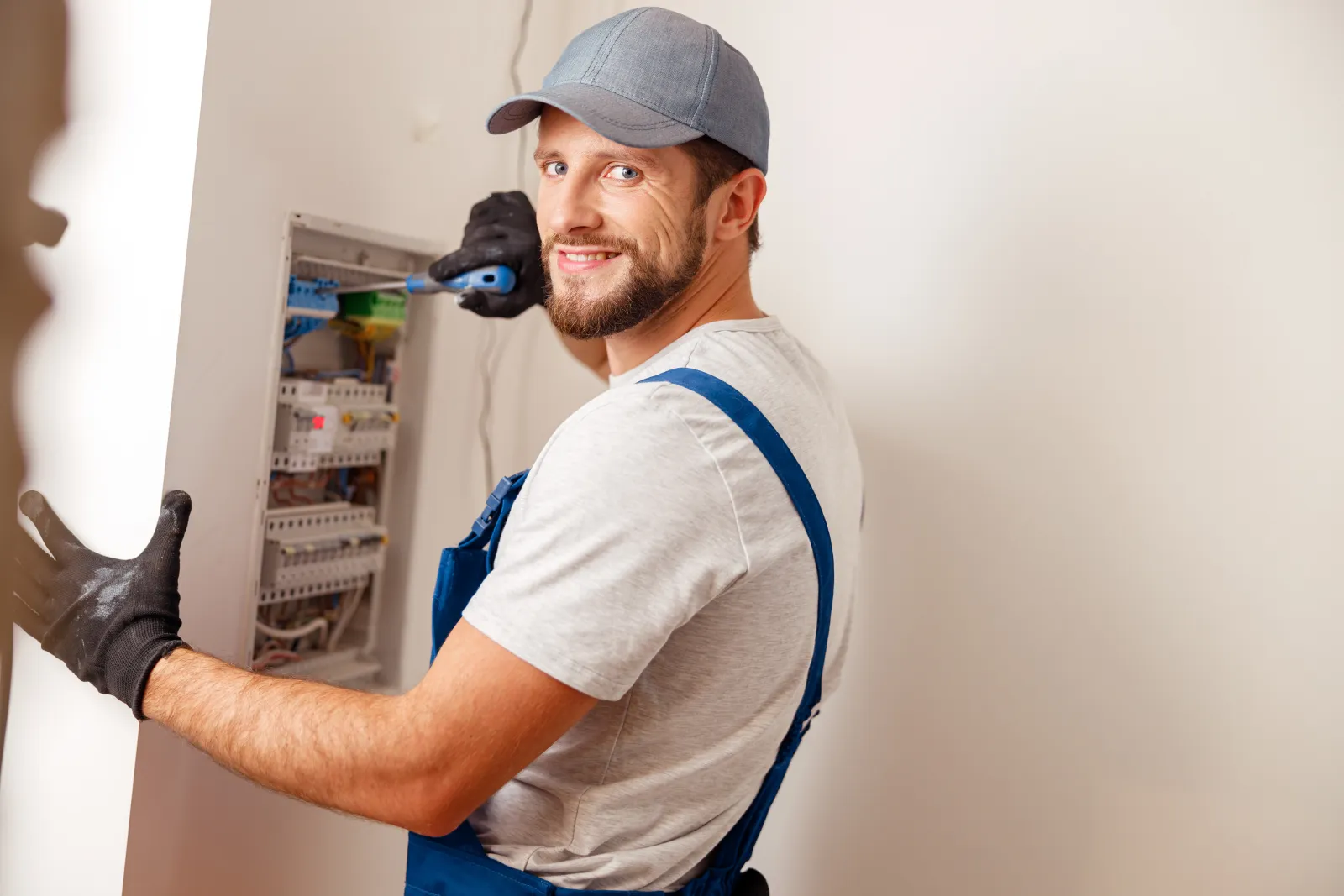 emergency-electrician-phoenix-panel-service Emergency electrician in Phoenix — a licensed electrician working on a home electrical panel during an emergency call in Phoenix, Arizona.