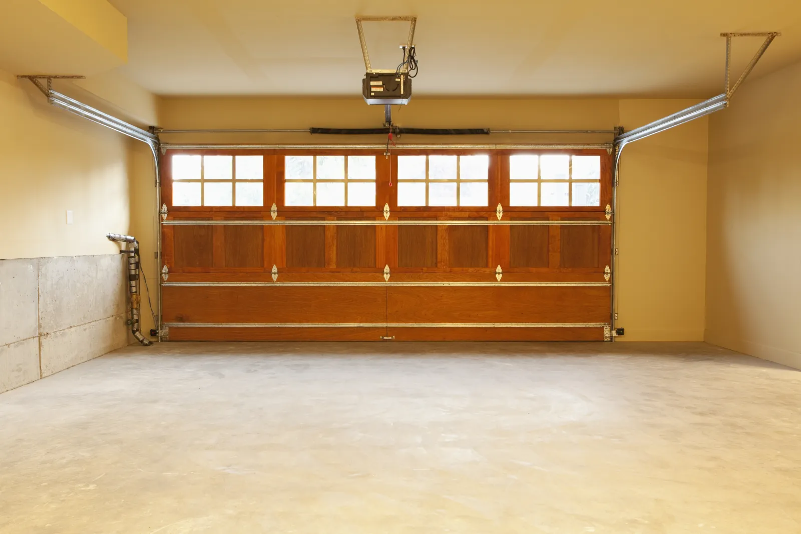 epoxy-garage-floor-phoenix-finished-coating Epoxy garage floors in Phoenix — a clean, empty two-car garage with a smooth epoxy-coated concrete floor in a Phoenix, Arizona home.