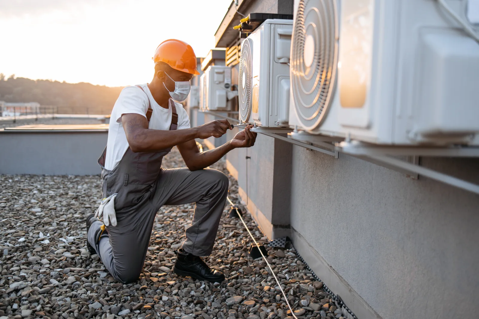 evaporative-cooler-repair-phoenix-startup-diagnostics An HVAC technician performing a seasonal startup inspection on a residential Phoenix rooftop cooling unit.