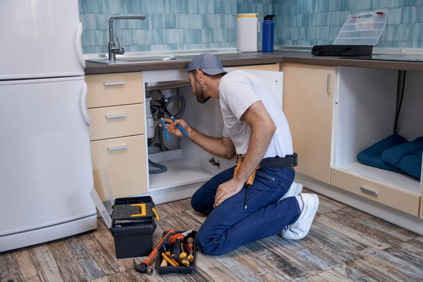 garbage-disposal-repair-phoenix-under-sink Garbage Disposal Repair in Phoenix — a plumber repairing a garbage disposal under a Phoenix, Arizona kitchen sink.