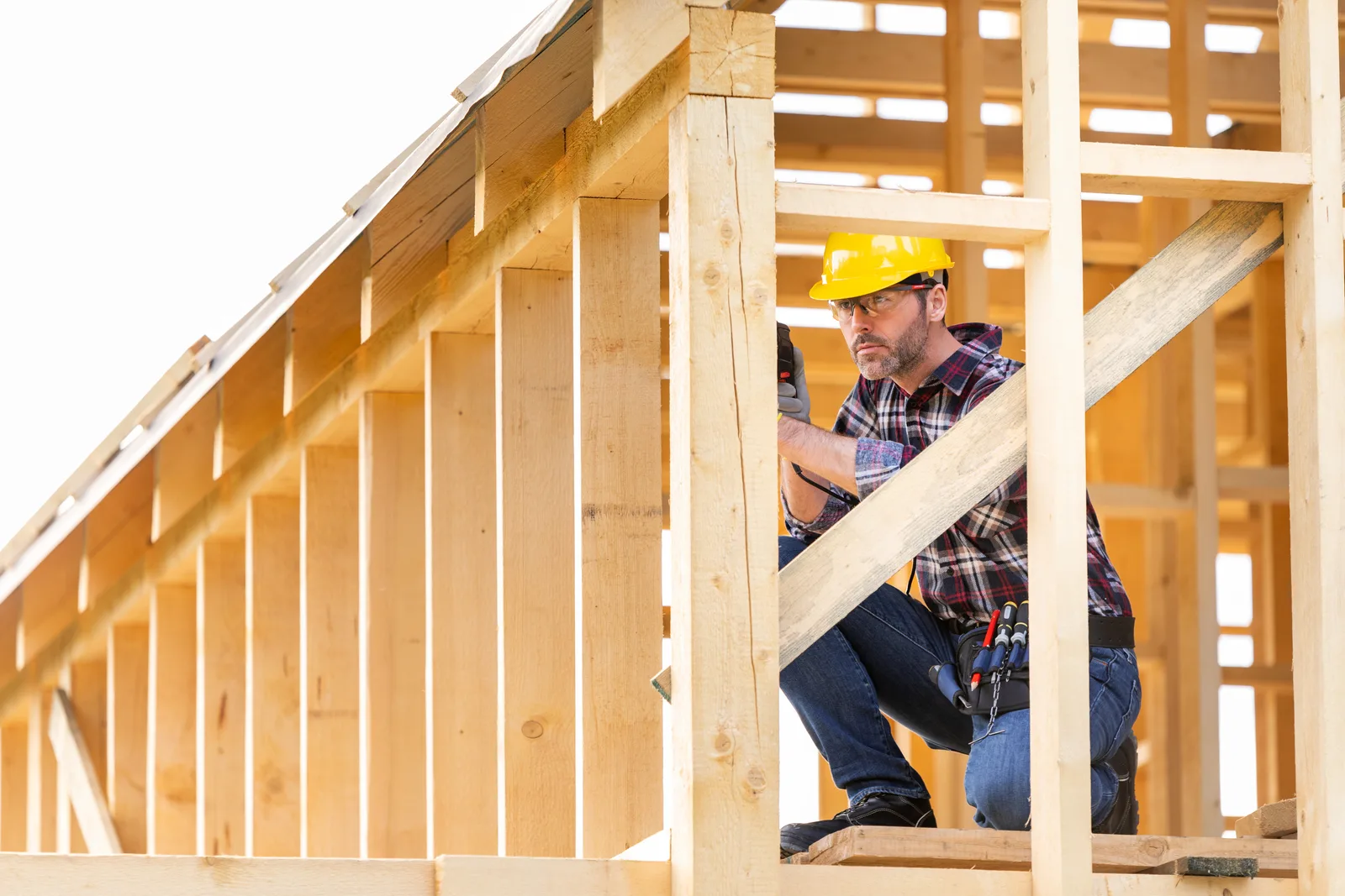 gazebo-builder-phoenix-carpenter-framing-roof-post Permits, setbacks, and HOA approval — a carpenter framing the roof post of a custom Phoenix gazebo.