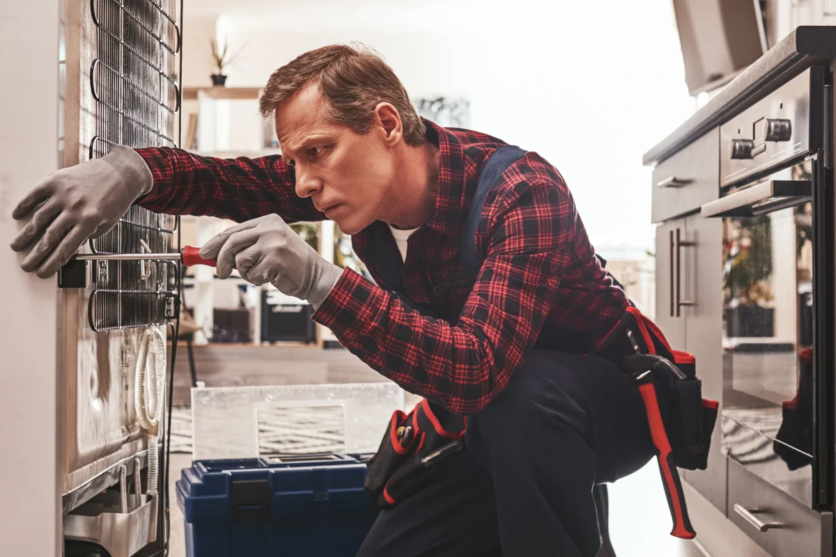 home-appliance-repair-phoenix-technician-kitchen Home Appliance Repair in Phoenix — a technician repairing a kitchen refrigerator in a Phoenix, Arizona home.