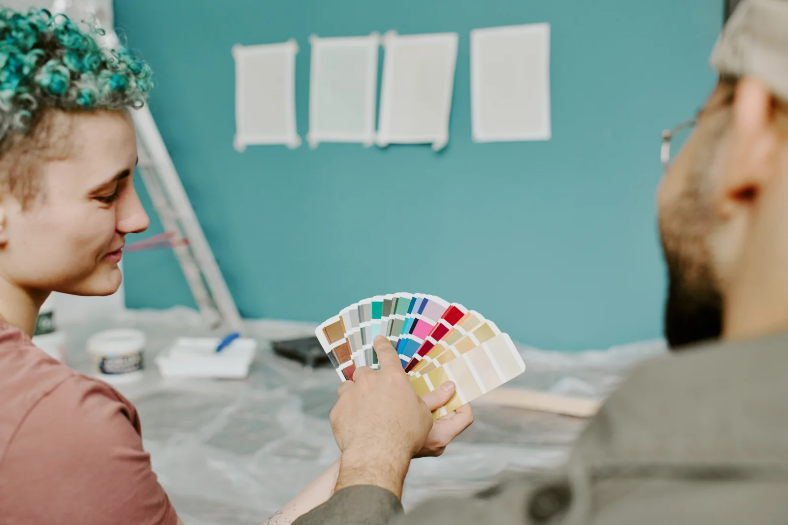 A homeowner and an interior painter in Phoenix reviewing paint color swatches before starting a room.