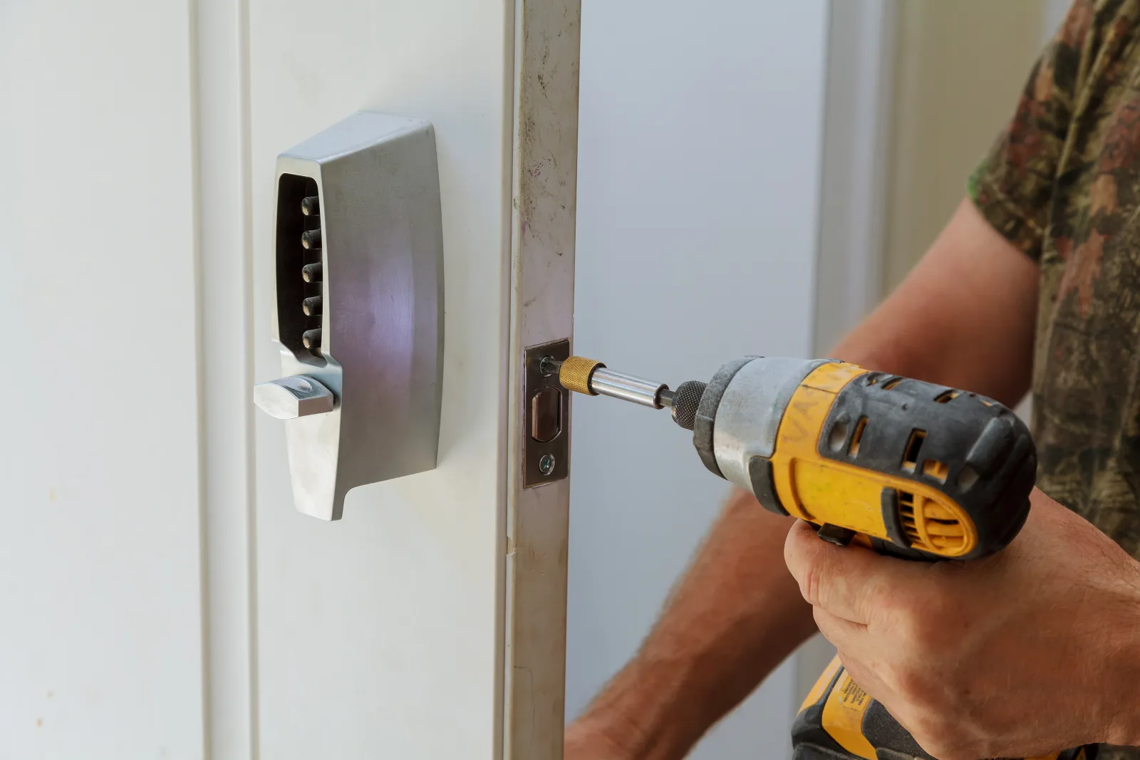 keypad-lock-installation-phoenix-installer A locksmith programming a newly installed keypad lock on a Phoenix front door during a service call.