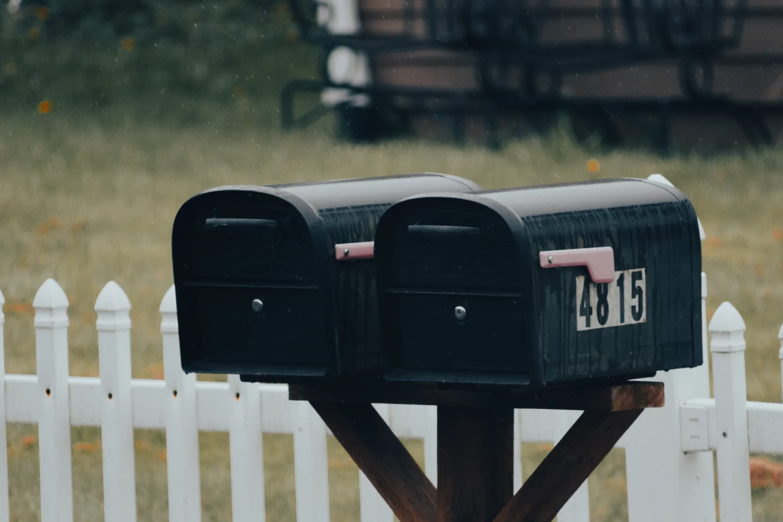 Mailbox locksmith in Phoenix, Arizona — a curbside residential mailbox with a locking door mounted on a wooden post.