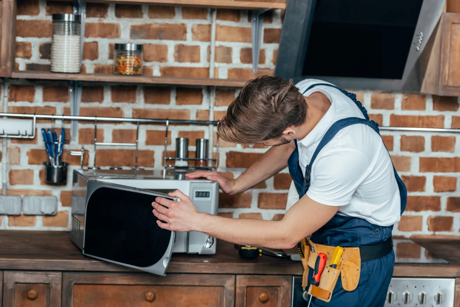 A Phoenix appliance technician checking the control panel of a microwave that stopped heating.