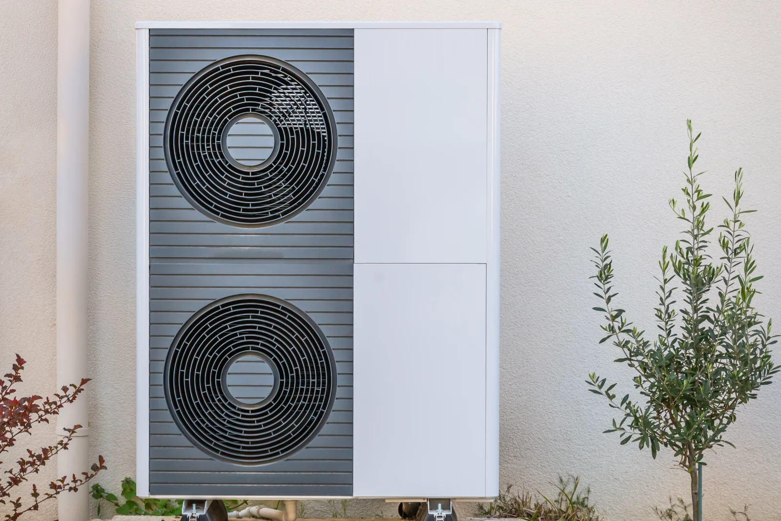 Phoenix mini split install — a ductless outdoor condenser unit mounted against a stucco exterior wall with desert landscaping.