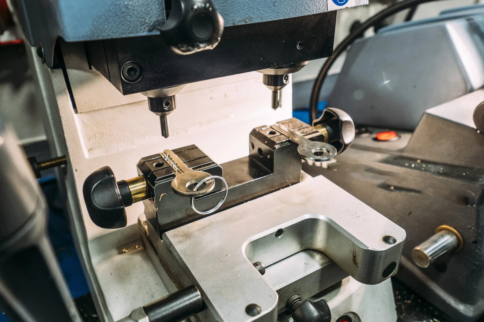 North Phoenix locksmith — a precision key-cutting machine cutting a new house key.