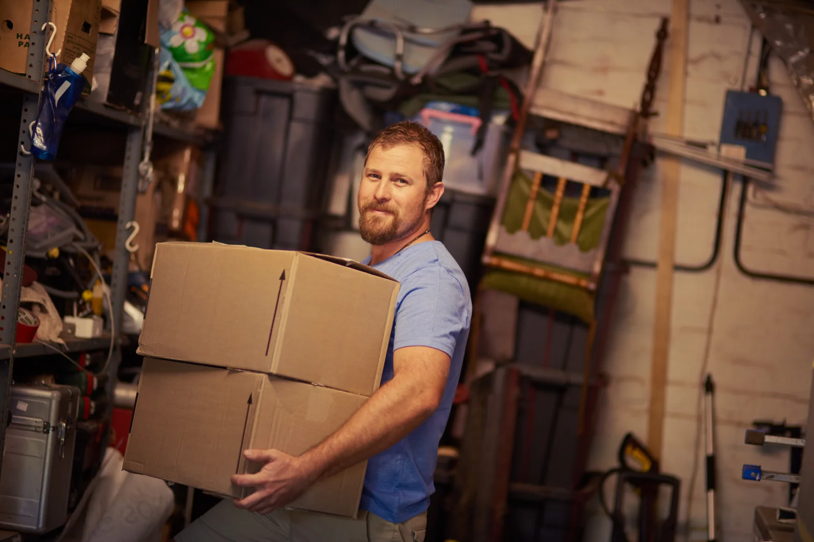 rat-pest-control-phoenix-garage-clutter-prep A Phoenix homeowner clearing stacked boxes and clutter from a garage before rat control treatment.