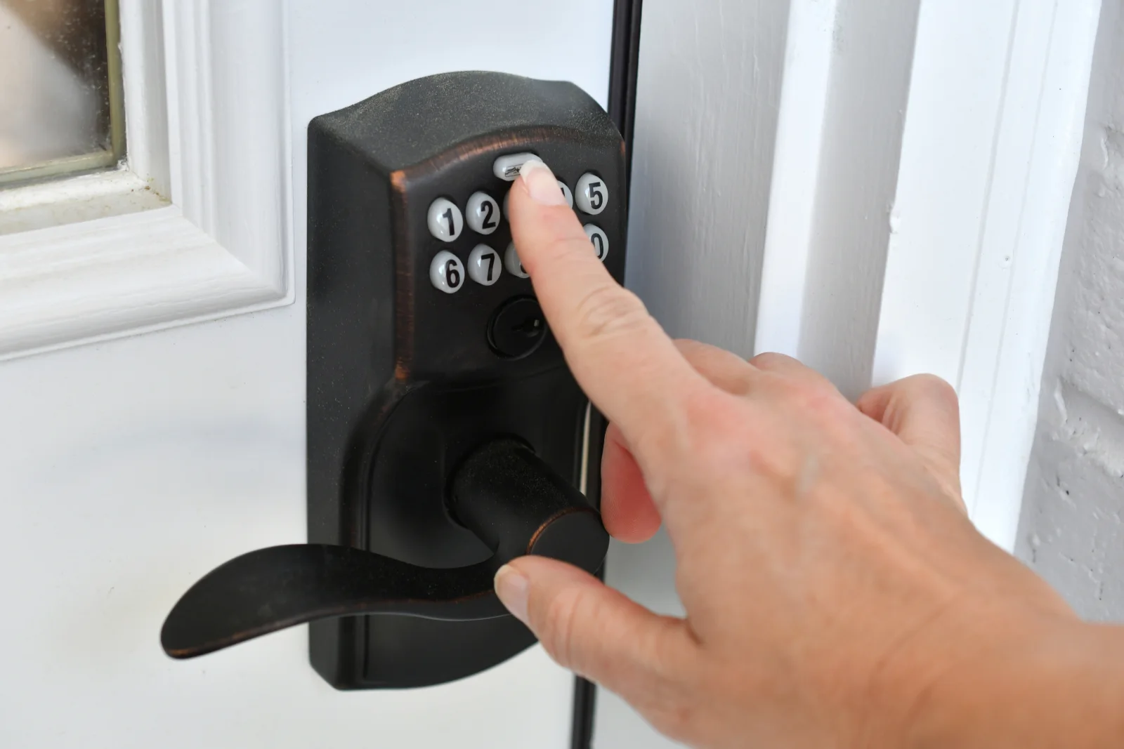 residential-locksmith-phoenix-smart-lock-install A locksmith programs a keypad smart lock on the front door of a Phoenix home during a residential installation.