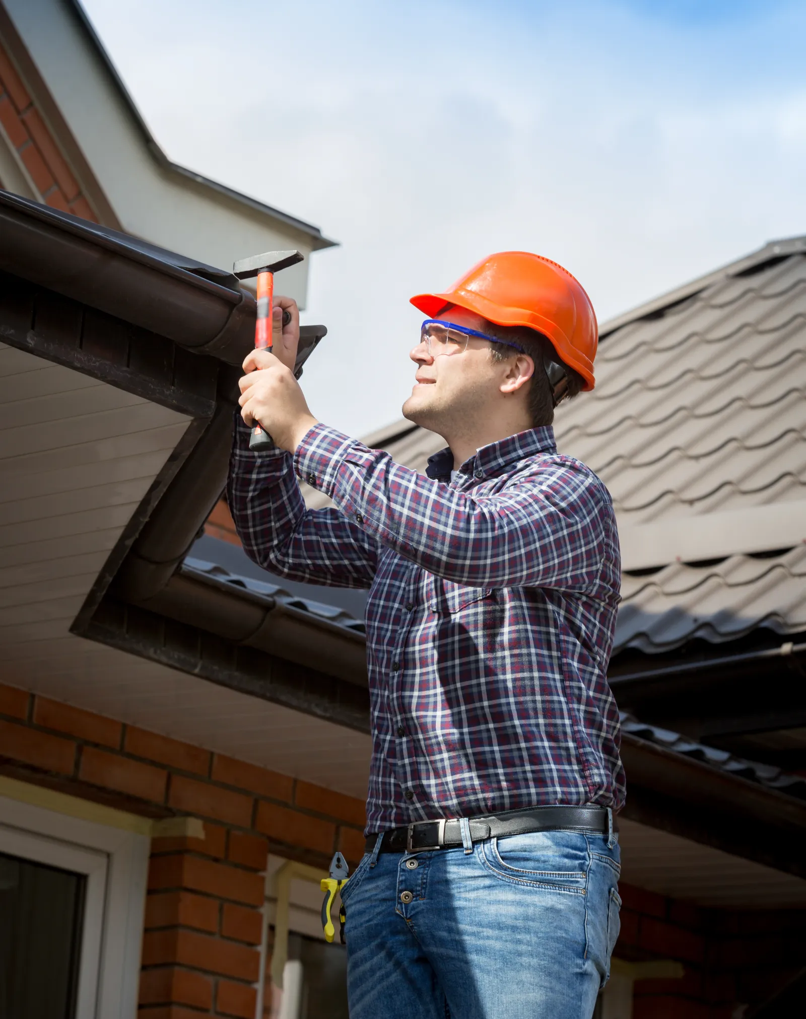 roof-hail-damage-repair-phoenix-roofer A roofer inspecting a residential roof in the Phoenix area, one of the Valley homes where ShowUp Promise connects owners with a hail damage repair pro.