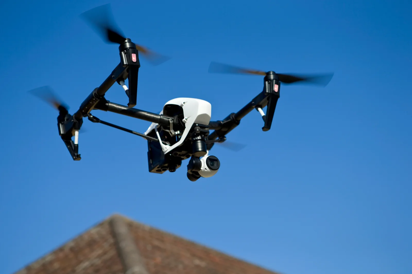 roof-inspection-phoenix-az-drone A drone hovering over a Phoenix residential roofline during an aerial roof inspection ahead of monsoon season.