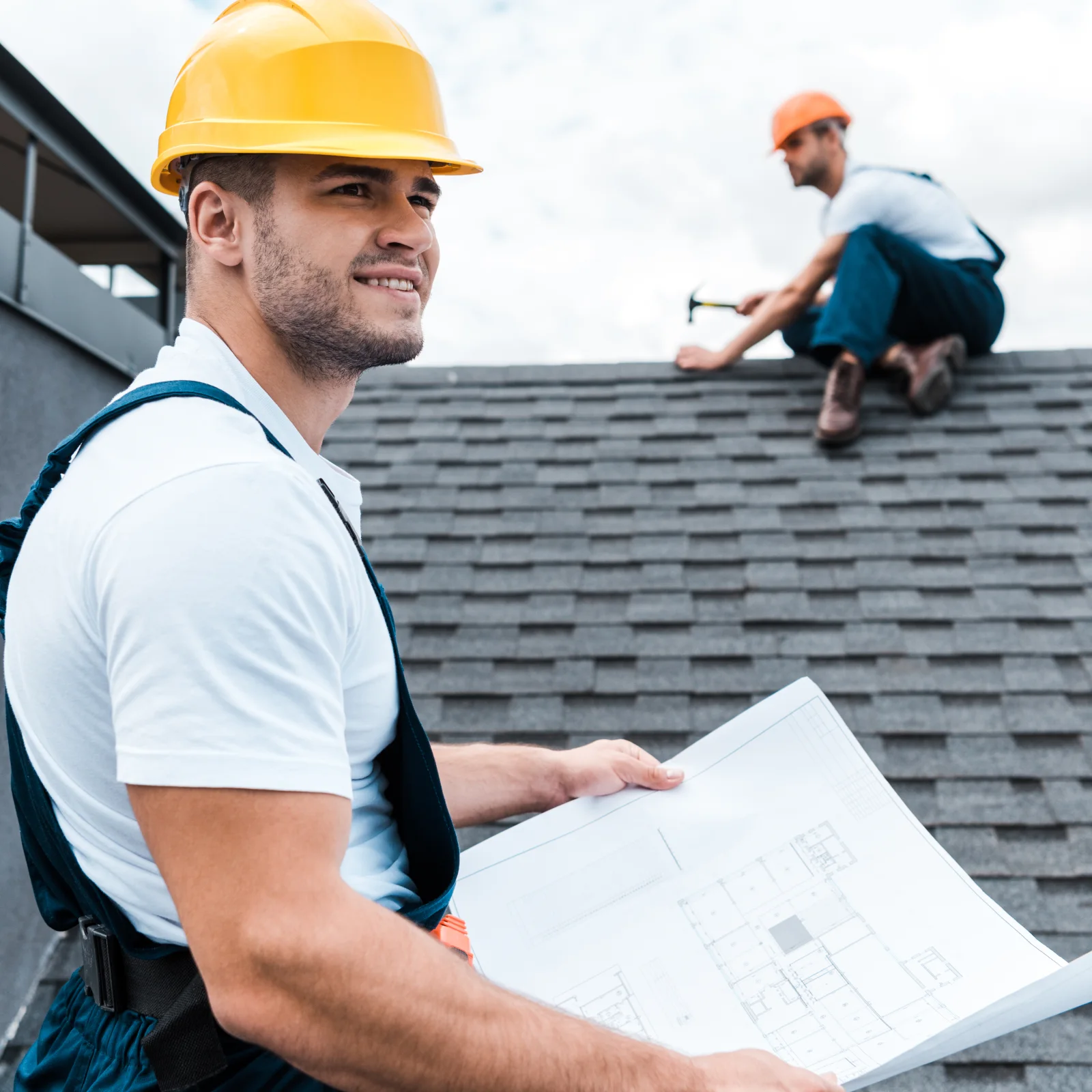 roof-inspection-phoenix-az-inspector Roof inspection in Phoenix, Arizona — a uniformed roofing inspector examining shingles on a residential rooftop under clear desert skies.