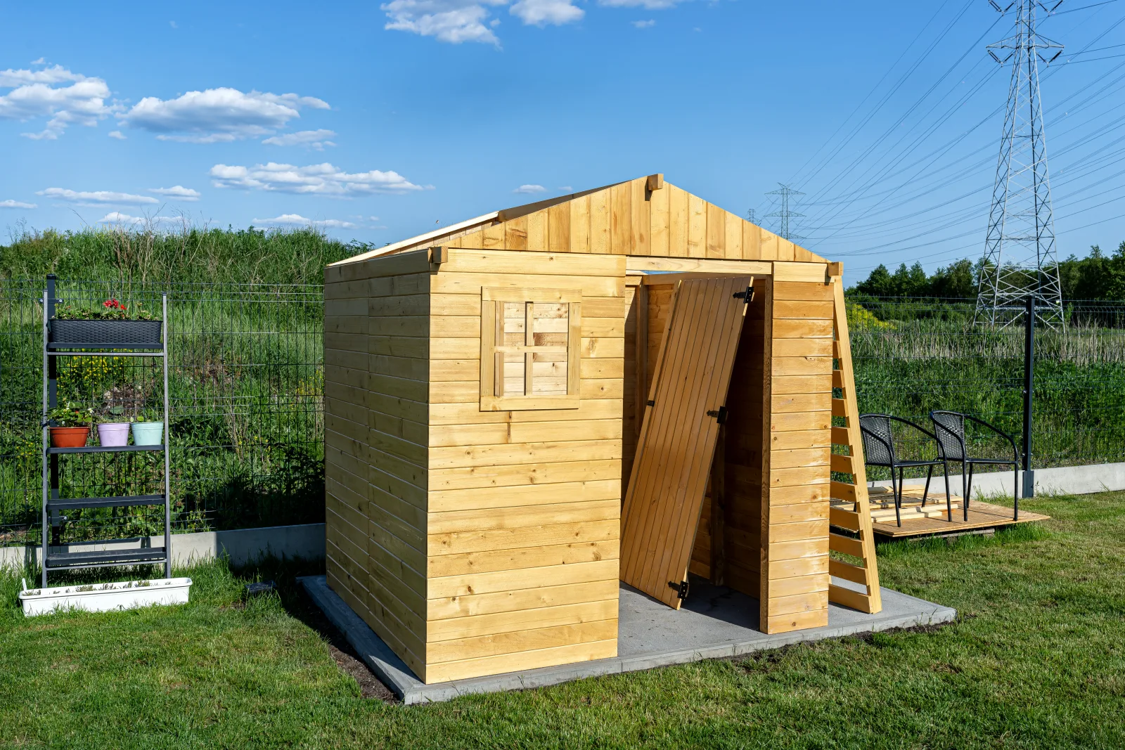 A finished custom shed built in a Phoenix-area backyard, matching the home's exterior for HOA approval.