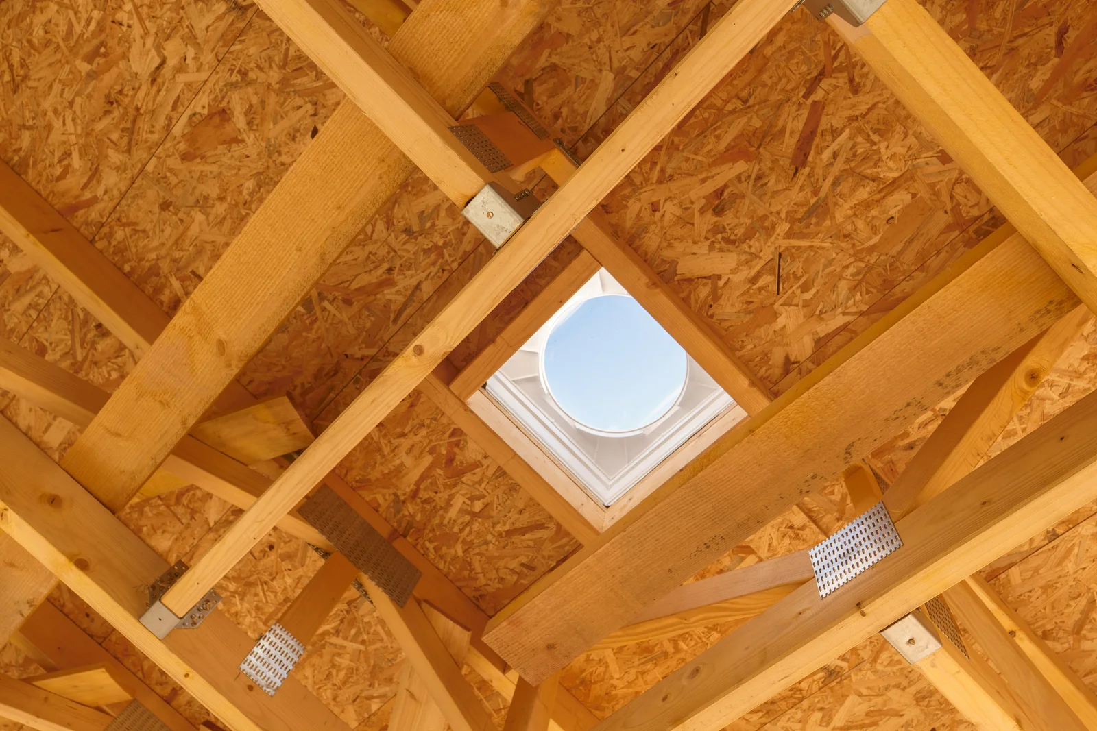 whole-house-fan-installation-phoenix-attic-roof-vent-opening Whole house fan installation in Phoenix, Arizona — a roof and attic framing cutout prepared for whole house fan ventilation.