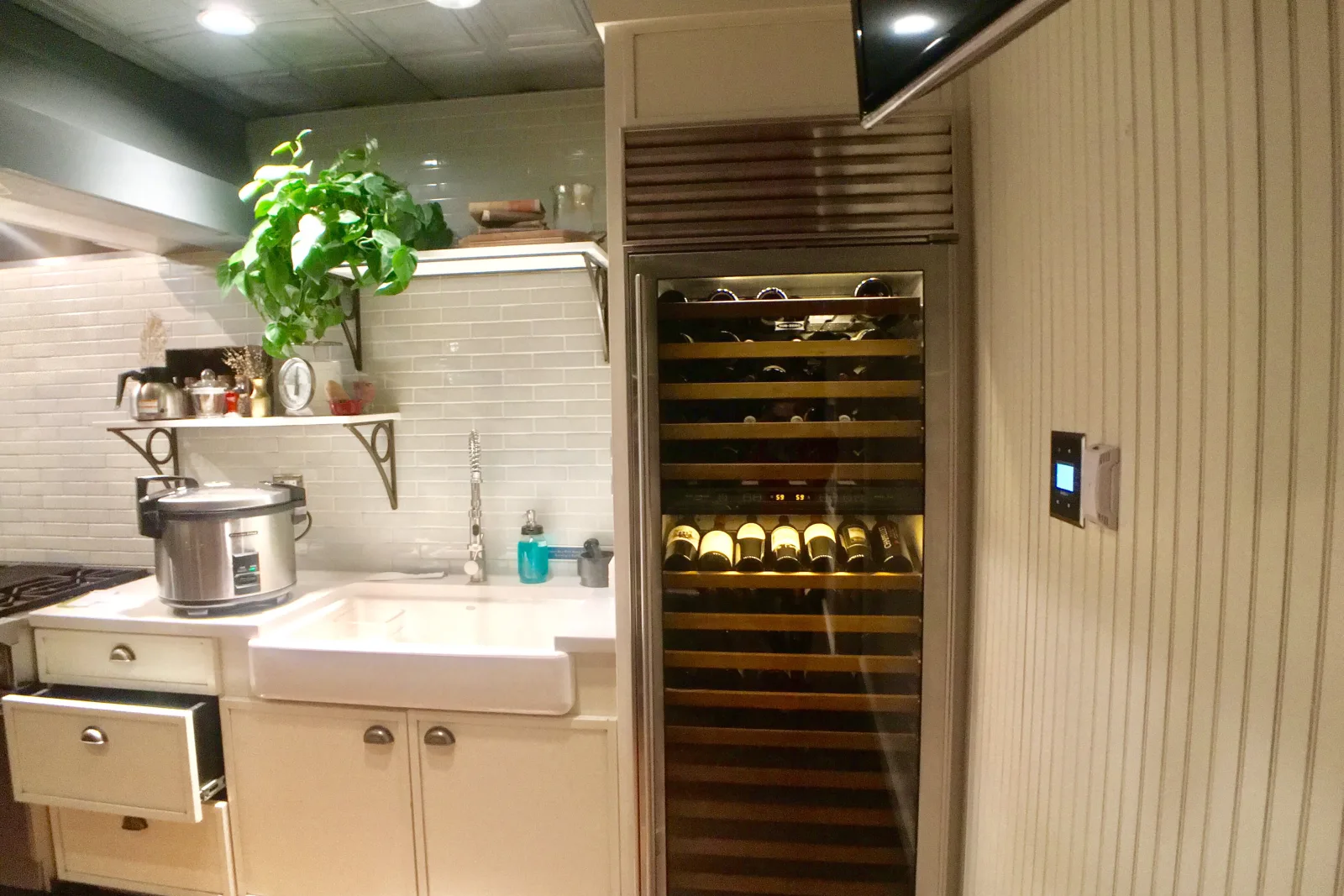 A dual-zone built-in wine cooler installed flush in Phoenix kitchen cabinetry with a clear front vent grille, the kind of built-in and freestanding unit an appliance pro checks for airflow before repairing.