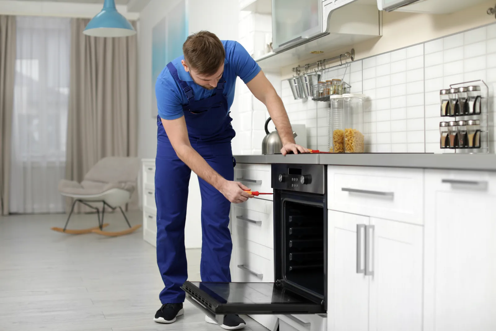 wolf-repair-phoenix-technician-diagnosing-built-in-wall-oven A Phoenix appliance technician diagnosing a Wolf built-in wall oven that will not reach temperature.